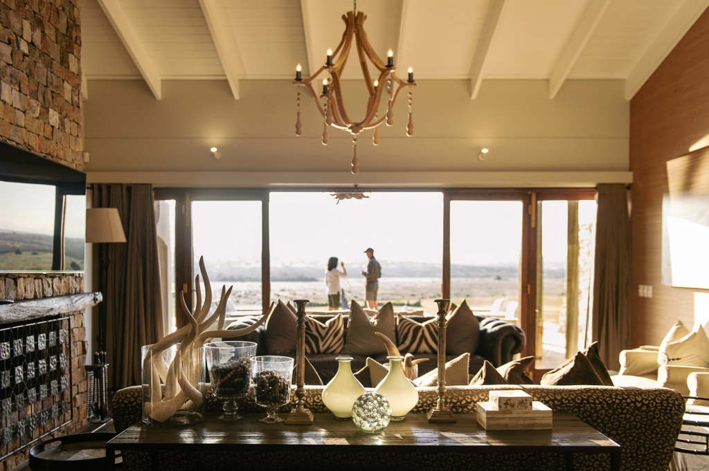 A cozy living room with stylish decor and large windows showing a scenic view.